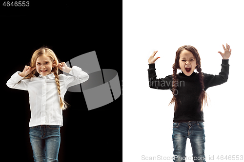 Image of portrait of two happy girls on a white and black background