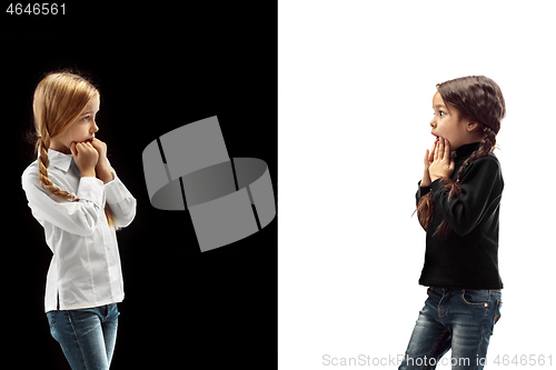 Image of portrait of two happy girls on a white and black background