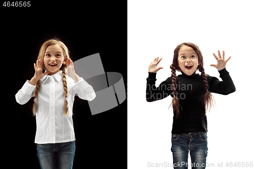 Image of portrait of two happy girls on a white and black background