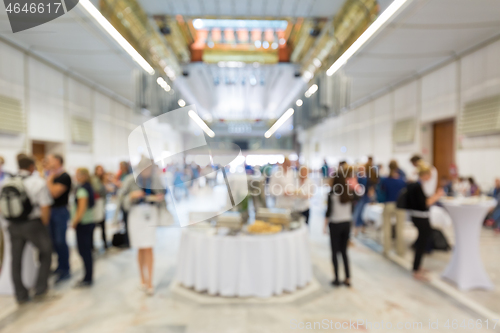 Image of Abstract blurred people socializing during lunch break at business conference.