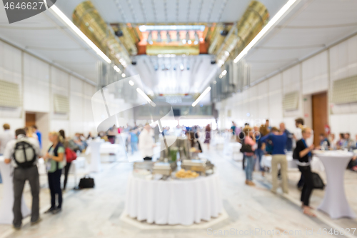 Image of Abstract blurred people socializing during lunch break at business conference.