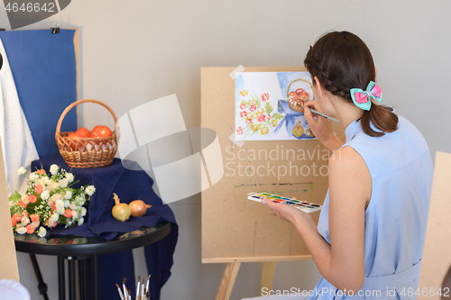 Image of artist draws still life watercolor paints on easel