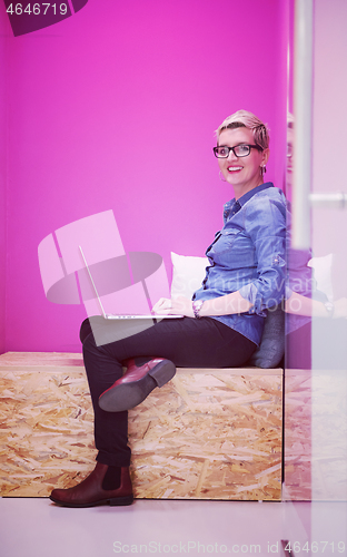 Image of woman in crative box working on laptop