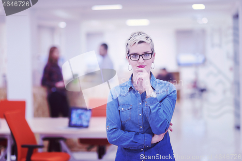 Image of portrait of young business woman at office with team in backgrou