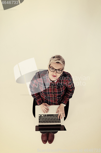 Image of top view of young business woman working on laptop computer