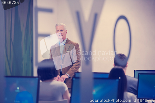 Image of teacher and students in computer lab classroom