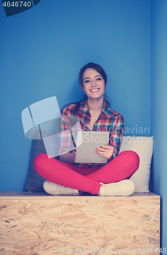 Image of woman in crative box working on tablet