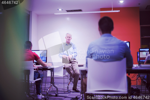 Image of teacher and students in computer lab classroom