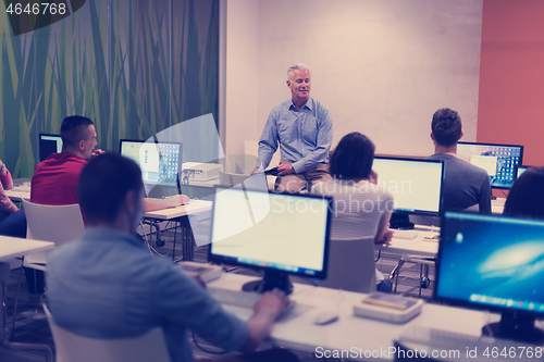 Image of teacher and students in computer lab classroom