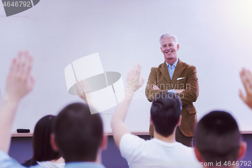 Image of teacher with a group of students in classroom