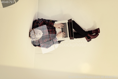 Image of top view of young business woman working on laptop computer