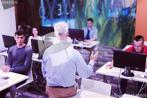 Image of teacher and students in computer lab classroom