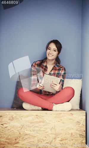 Image of woman in crative box working on tablet