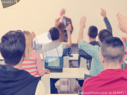 Image of students group raise hands up on class