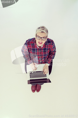Image of top view of young business woman working on laptop computer