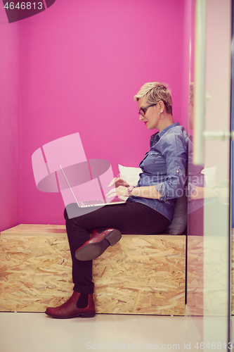 Image of woman in crative box working on laptop