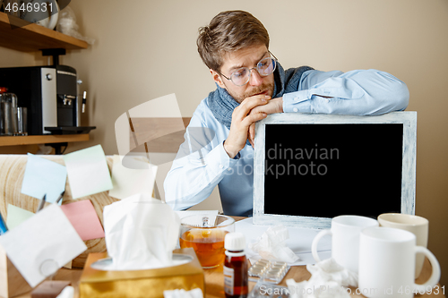 Image of Sick man while working in office, businessman caught cold, seasonal flu.