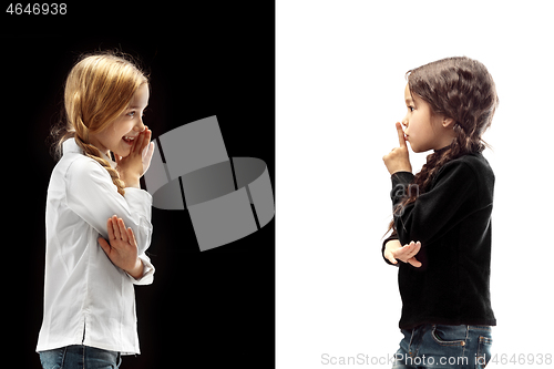 Image of The young teen girls whispering a secret behind her hand over pink background