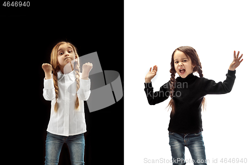 Image of Angry teen girls standing on studio background.