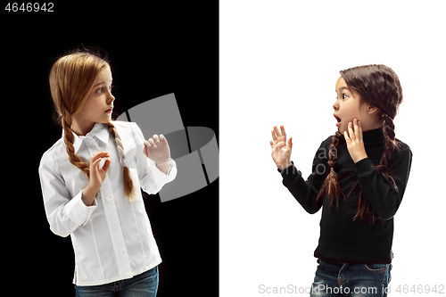 Image of portrait of two scared girls on a white and black background