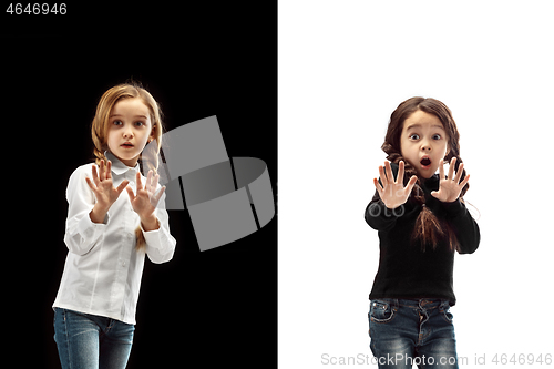 Image of portrait of two scared girls on a white and black background