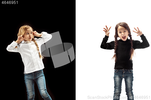 Image of Angry teen girls standing on studio background.