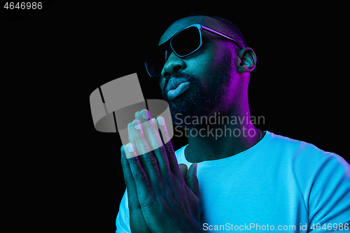 Image of The neon portrait of a young smiling african man