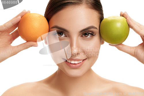 Image of portrait of attractive caucasian smiling woman isolated on white studio shot eating green apple