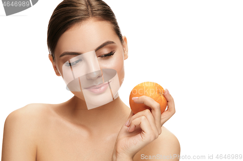 Image of portrait of attractive caucasian smiling woman isolated on white studio shot eating green apple