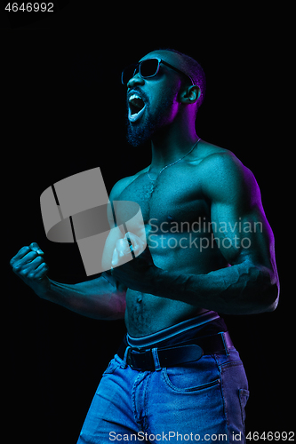 Image of Close up portrait of a young naked african man indoors