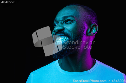 Image of The neon portrait of a young smiling african man