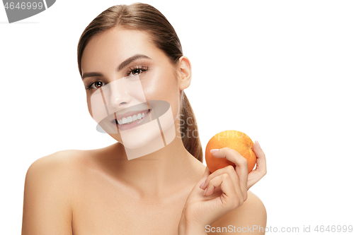 Image of portrait of attractive caucasian smiling woman isolated on white studio shot eating green apple