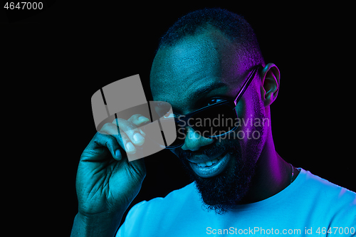 Image of The neon portrait of a young smiling african man