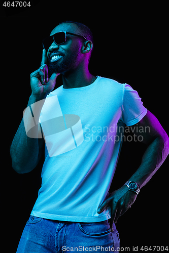 Image of The neon portrait of a young smiling african man