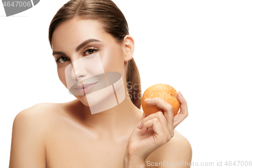 Image of portrait of attractive caucasian smiling woman isolated on white studio shot eating green apple