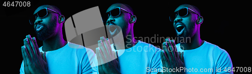 Image of The neon portrait of a young smiling african man