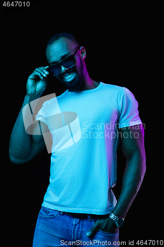 Image of The neon portrait of a young smiling african man