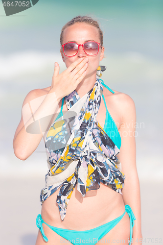 Image of Woman sending a kiss from summer vacations.