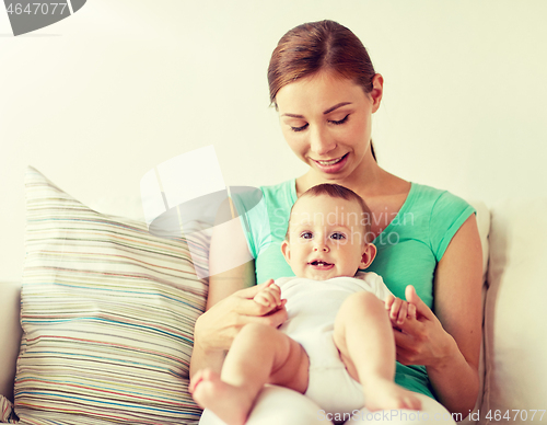 Image of happy young mother with little baby at home