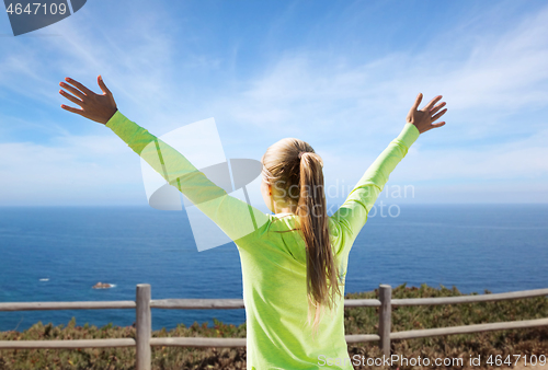 Image of happy woman in sports clothes over sea background