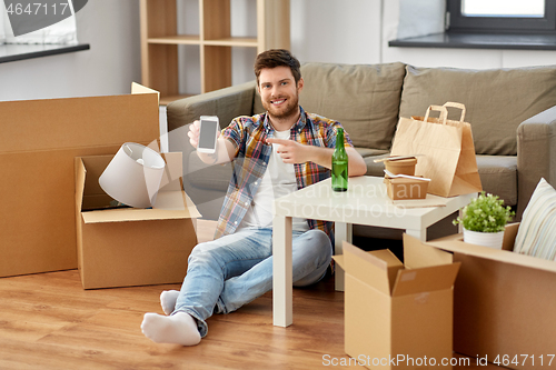 Image of man with smartphone and takeaway food moving