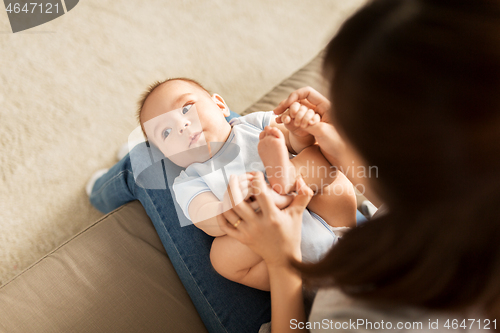 Image of young mother with little asian baby son at home