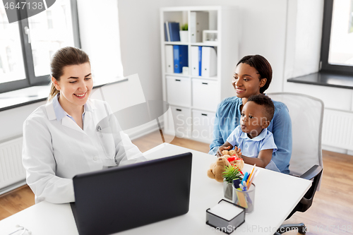 Image of mother with baby and doctor with laptop at clinic