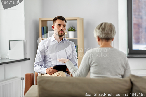 Image of psychologist listening to senior woman patient