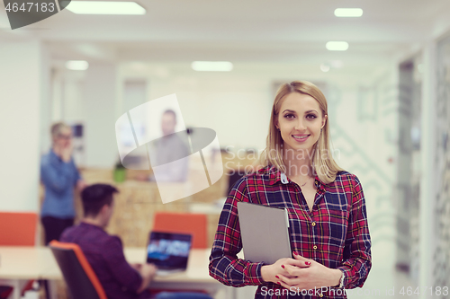 Image of portrait of young business woman at office with team in backgrou