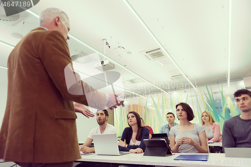 Image of teacher with a group of students in classroom