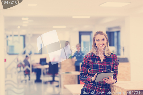 Image of portrait of young business woman at office with team in backgrou