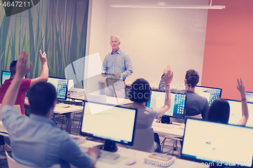 Image of teacher and students in computer lab classroom