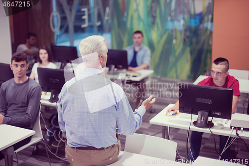 Image of teacher and students in computer lab classroom