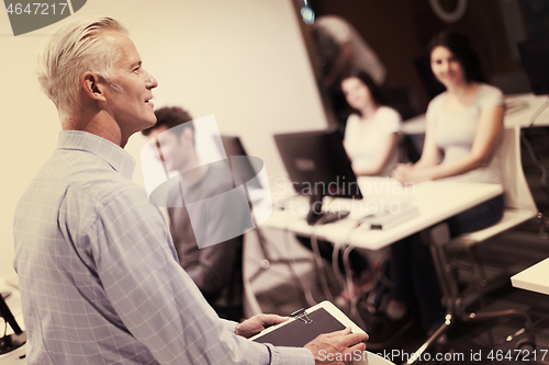 Image of teacher and students in computer lab classroom